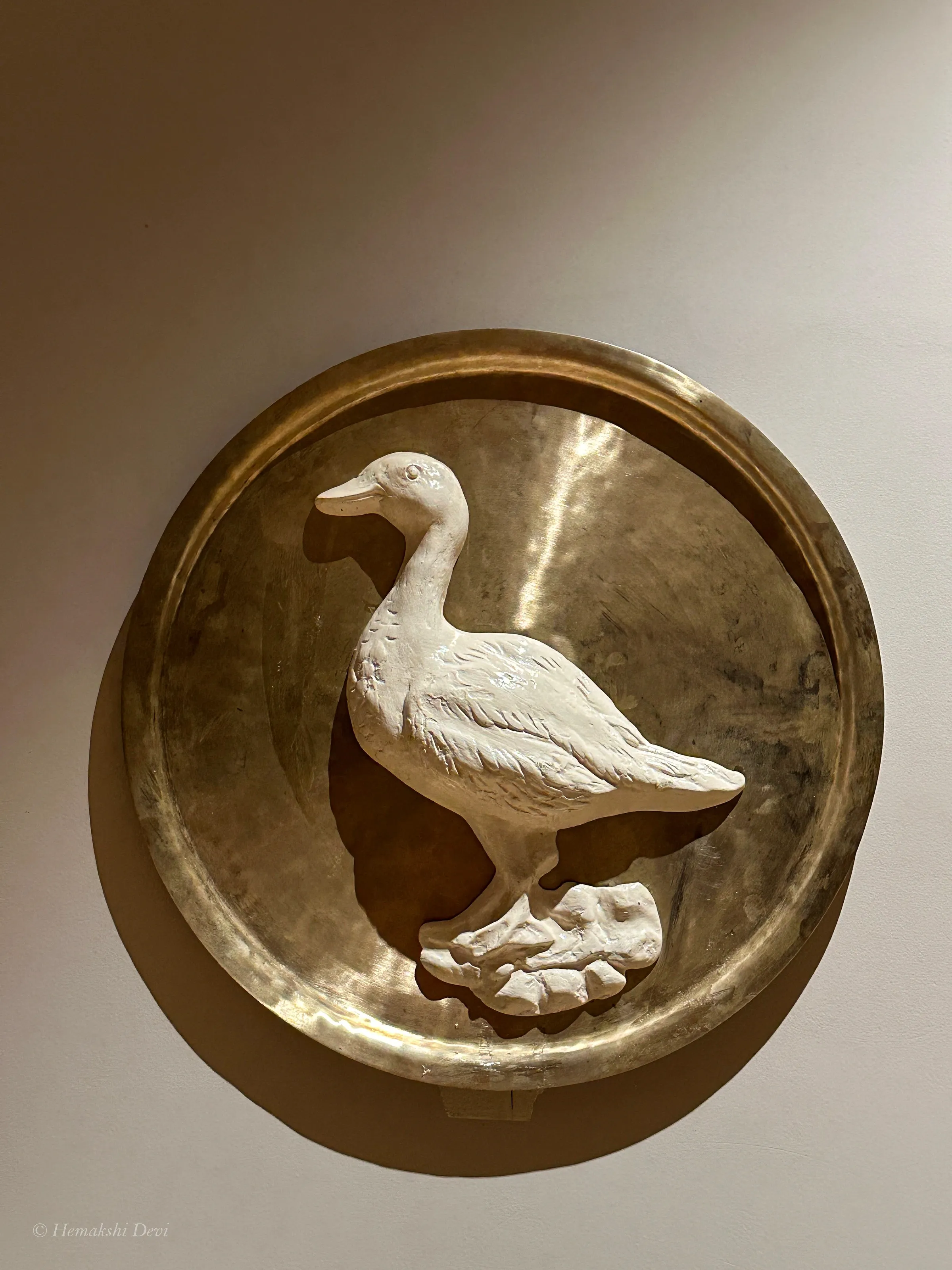 Detail of a bell-metal medallion with a Kaziranga bird relief